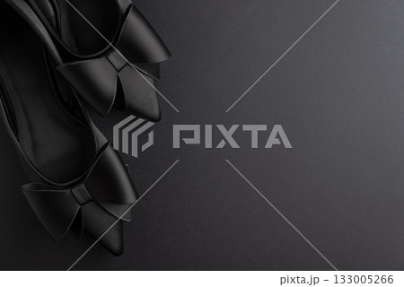 Black Friday Fashion: Elegant Black Shoes with Bows on Black Background Black Friday Fashion: Elegant Black Shoes with Bows on Black Background 133005266