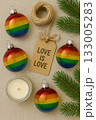 Festive Christmas Pride Flat Lay with Rainbow Ornaments, Pinecones, and Candles 133005283