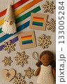 Festive Christmas Pride Flat Lay with Rainbow Ornaments, Pinecones, and Candles 133005284