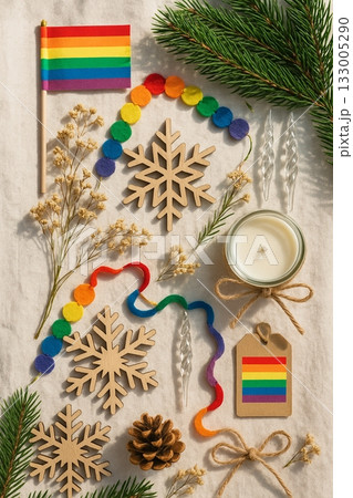 Festive Christmas Pride Flat Lay with Rainbow Ornaments, Pinecones, and Candles 133005290