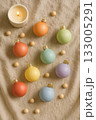 Festive Christmas Pride Flat Lay with Rainbow Ornaments, Pinecones, and Candles 133005291