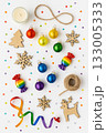 Festive Christmas Pride Flat Lay with Rainbow Ornaments, Pinecones, and Candles 133005333