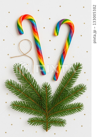 Festive Christmas Pride Flat Lay with Rainbow Ornaments, Pinecones, and Candles 133005382