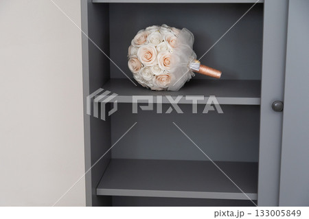 Bouquet on shelf in bright interior. Romantic tenderness, gentle design, and timeless simplicity of home life. Bouquet on shelf in bright interior. Romantic tenderness, gentle design, and timeless simplicity of home life. 133005849