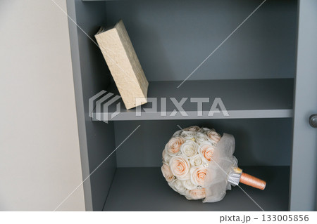 Bouquet and book on shelf. Nostalgia, tenderness, and emotional stillness of home memories. 133005856