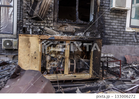 Ground level view of fire aftermath charred brick wall and damaged generator foreground twisted metal, shattered glass, and scorched AC units revealing intense destruction and electrical vulnerability Ground level view of fire aftermath charred brick wall and damaged generator foreground twisted metal, shattered glass, and scorched AC units revealing intense destruction and electrical vulnerability 133006272