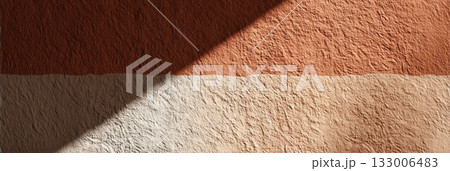 Textured clay wall with rough surface and natural color gradient in warm earth tones Textured clay wall with rough surface and natural color gradient in warm earth tones 133006483