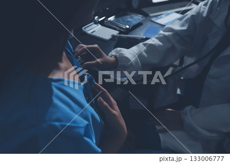 healthy concept; Doctor checking patient's heart with stethoscope at a hospital healthy concept; Doctor checking patient's heart with stethoscope at a hospital 133006777