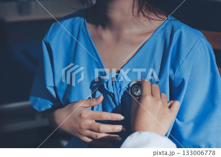healthy concept; Doctor checking patient's heart with stethoscope at a hospital healthy concept; Doctor checking patient's heart with stethoscope at a hospital 133006778