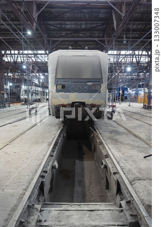 An electric train at a train construction and repair plant 133007348