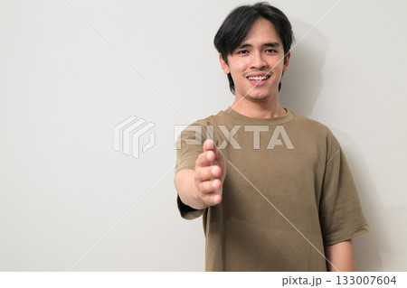 Portrait of handsome Young Asian Thai man offering handshake against white background 133007604