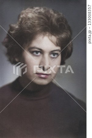 A vintage portrait of a young, attractive brunette with a beautiful 1960s-style hairstyle. Retro photo from 1965. 133008357