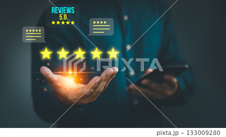 Businessman holding glowing five star customer review rating, symbolizing excellent service, online feedback, brand reputation, client satisfaction, testimonial, and digital business success. 133009280