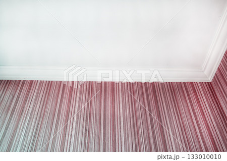 White ceiling and pink striped wallpaper with crown molding close up White ceiling and pink striped wallpaper with crown molding close up 133010010