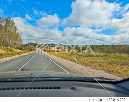 Empty country road view from car autumn landscape with clouds horizontal frame Empty country road view from car autumn landscape with clouds horizontal frame 133010962