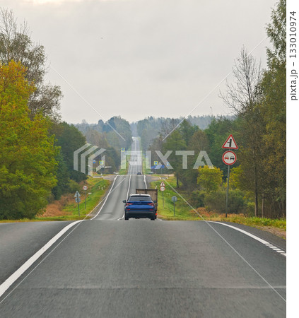 Country road view from car with truck and car autumn landscape horizontal frame Country road view from car with truck and car autumn landscape horizontal frame 133010974