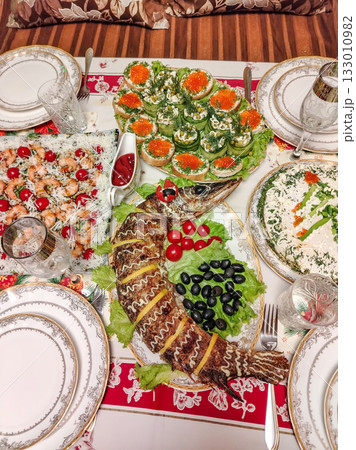 Festive home dinner table with caviar and shrimp elegant table setting vertical frame 133010982