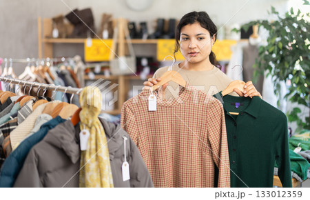 Latina chooses a warm dress in the store 133012359