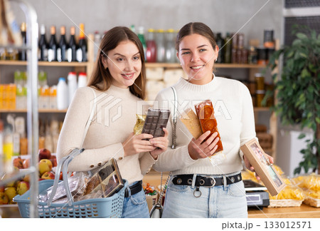 Women choose Spanish sweets in the store 133012571