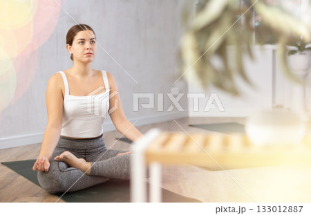 Young woman doing yoga in fitness studio Young woman doing yoga in fitness studio 133012887