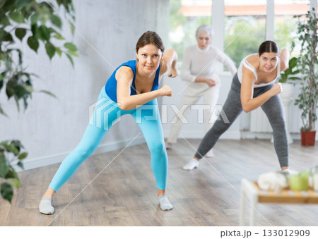 Positive women engaged in active dancing Positive women engaged in active dancing 133012909