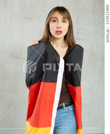 Young sad pretty woman displaying flag of germany 133012960
