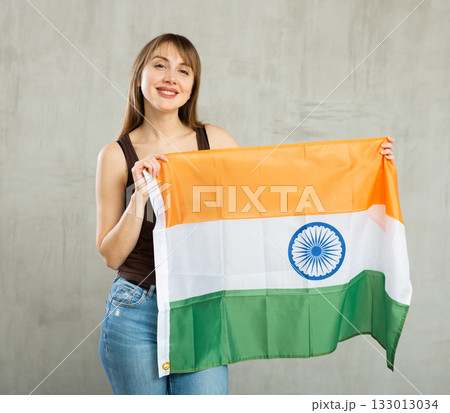 Young cheerful woman holding India flag 133013034
