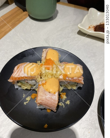 An assortment of fresh sushi, artfully arranged with a variety of toppings and vibrant colors. This traditional Japanese dish combines vinegared rice, seafood, and vegetables for an experience. 133013040