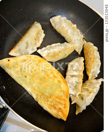 Delicious Korean mandu dumplings with a golden, crispy exterior and flavorful filling. Perfect as an appetizer, snack, or side dish, offering a delightful taste in every bite. 133013048