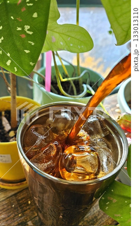 Refreshing iced tea served in a chilled glass, featuring a deep amber hue and a light citrus garnish. Perfect for a cooling and revitalizing drink on warm days. Refreshing iced tea served in a chilled glass, featuring a deep amber hue and a light citrus garnish. Perfect for a cooling and revitalizing drink on warm days. 133013110