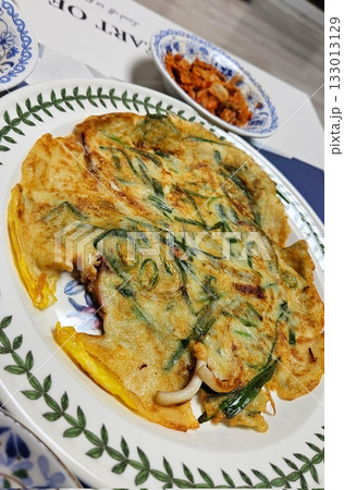 Crispy and savory Korean Pajeon, or scallion pancake, made with green onions and a variety of vegetables. A delicious, traditional Korean snack perfect for any meal. Crispy and savory Korean Pajeon, or scallion pancake, made with green onions and a variety of vegetables. A delicious, traditional Korean snack perfect for any meal. 133013129