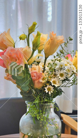 A vibrant bouquet of fresh flowers in a variety of colors, beautifully arranged to highlight their natural beauty. Perfect for celebrating special occasions or brightening up any space. 133013130