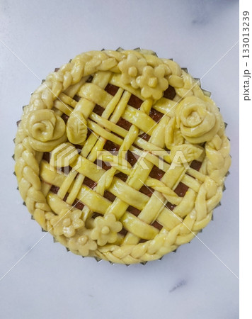 Warm and comforting apple pie with a golden, flaky crust and sweet cinnamon-spiced apple filling, offering a perfect bite of classic homemade flavor and cozy indulgence in every slice. 133013239