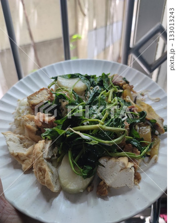 Rujak Petis, a mixed salad lathered with a thick savoury sauce of shrimp paste and smashed peanut. A traditional fruit and vegetable salad dish commonly found in Indonesia. 133013243