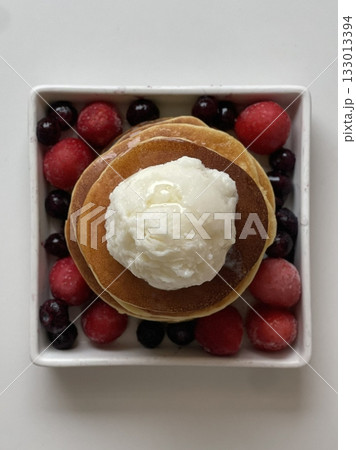 Fluffy and golden pancakes stacked high, served with syrup, butter, or fresh fruits. A warm and comforting breakfast classic that’s soft, sweet, and perfectly satisfying. 133013394