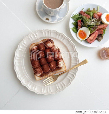 Golden, fluffy French toast with a crisp edge and soft center, topped with syrup, fruits, or powdered sugar—offering a perfect balance of sweetness, warmth, and comfort in every delightful bite. 133013404