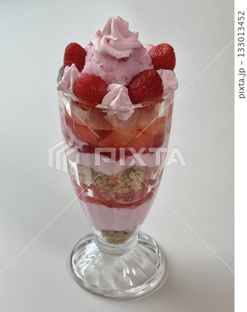 Healthy breakfast of strawberry parfait made with fresh fruit, and yogurt over a rustic white table. Selective focus with blurred background and foreground. 133013452