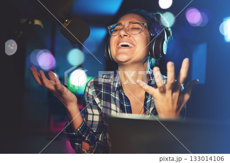 Radio DJ, headphone and microphone, woman is excited with singing or talking, broadcast media and announcement. Female in studio booth, recording and happiness with smile, excitement and carefree 133014106