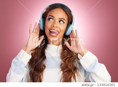 Mockup, tongue out and woman with headphones, streaming music and happy against a pink studio background. Headset, female and lady with joy, silly and listening to radio with audio, song and sounds 133014165