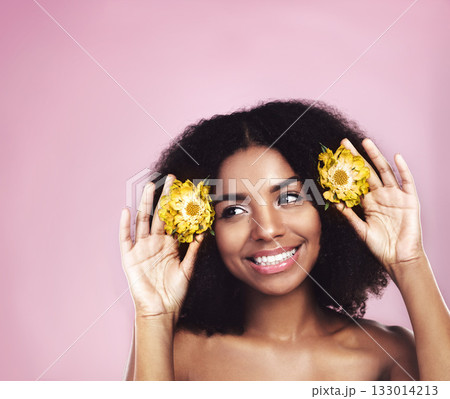 Happy woman, hair care and thinking with flowers in studio, pink background and sustainable mockup. Face, african model and daisy plants in afro to think of natural skincare, beauty ideas and makeup 133014213