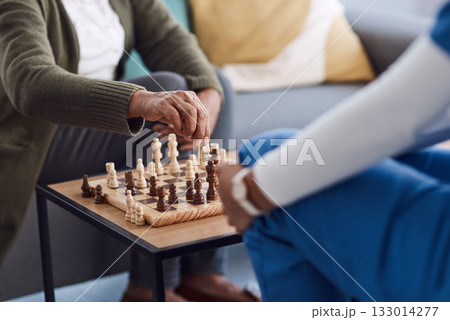Hands, chess a nurse with a patient in a nursing home playing a game of strategy during a visit. Healthcare, medical or insurance with a medicine professional and resident in the living room together Hands, chess a nurse with a patient in a nursing home playing a game of strategy during a visit. Healthcare, medical or insurance with a medicine professional and resident in the living room together 133014277