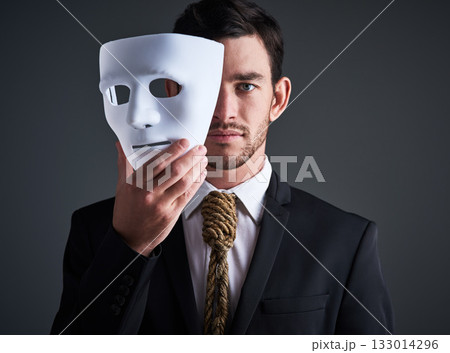 Two faced portrait, mask and fake businessman in a studio with serious face with secret personality. Manager and corporate male with rope tie showing corporate slavery and control in business suit 133014296
