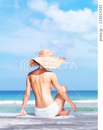 Travel, relax and topless with woman at beach for sunbathing, summer break and freedom in Bali. Sexy, blue sky and tropical with back of girl in bikini on vacation for mockup, peace or beauty on trip 133014391