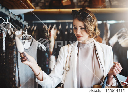 Shopping, fashion and woman with a sale, boutique and discount items with retail, client and luxury. Female person, customer and shopper with price tag, store and outfit choice with clothes selection 133014515