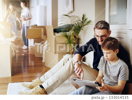 Man, boy and tablet, playing games and relax, break from unpacking and moving into new house. Father, son and wireless tech with property, real estate and rest with video game online and bonding Man, boy and tablet, playing games and relax, break from unpacking and moving into new house. Father, son and wireless tech with property, real estate and rest with video game online and bonding 133014535