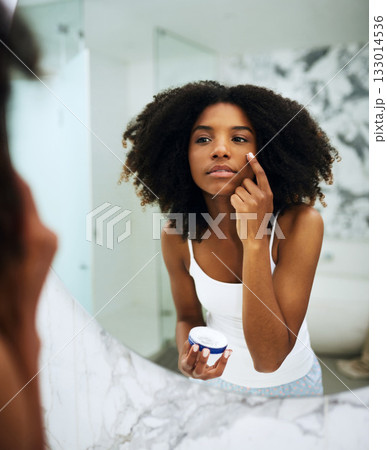 Skin care, bathroom mirror and black woman with lotion, cosmetic product and morning grooming. Health, wellness and dermatology, skincare at home and girl in reflection with cream on face for beauty. Skin care, bathroom mirror and black woman with lotion, cosmetic product and morning grooming. Health, wellness and dermatology, skincare at home and girl in reflection with cream on face for beauty. 133014536