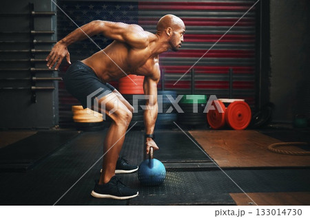 Fitness, weightlifting and black man with kettlebell in gym training for competition, health and body wellness. Sports, workout and exercise, African American athlete lifting with power and strength. Fitness, weightlifting and black man with kettlebell in gym training for competition, health and body wellness. Sports, workout and exercise, African American athlete lifting with power and strength. 133014730