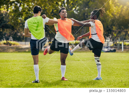 Sports men, training and outdoor rugby on a grass field with a team stretching legs as warm up. Athlete group together for fitness, exercise and workout for diversity sport with coach and teamwork Sports men, training and outdoor rugby on a grass field with a team stretching legs as warm up. Athlete group together for fitness, exercise and workout for diversity sport with coach and teamwork 133014803