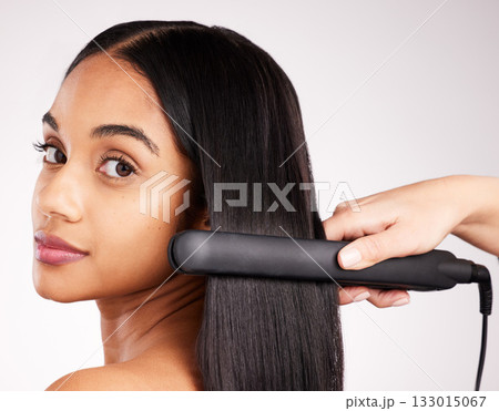 Woman flat iron and studio portrait with hair care, wellness and heat treatment by white background. Girl, model and healthy glow at hairdresser with electric tools for cosmetics, change and beauty 133015067