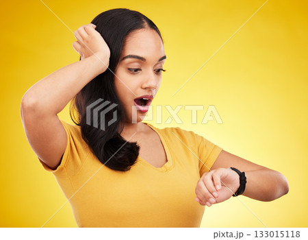 Late, watch and surprise of a woman in a studio looking at time with alarm feeling shocked. Isolated, yellow background and young female model with shock from watching the clock and smartwatch Late, watch and surprise of a woman in a studio looking at time with alarm feeling shocked. Isolated, yellow background and young female model with shock from watching the clock and smartwatch 133015118